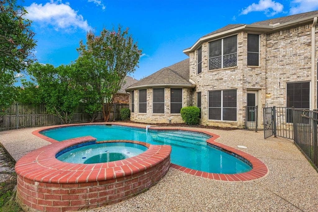 2412 Clearwood Lane, Flower Mound, TX 75028 Resort-style outdoor living takes center stage with a refreshing pool, raised spa and an inviting backyard designed for both quiet relaxation and effortless entertaining.
