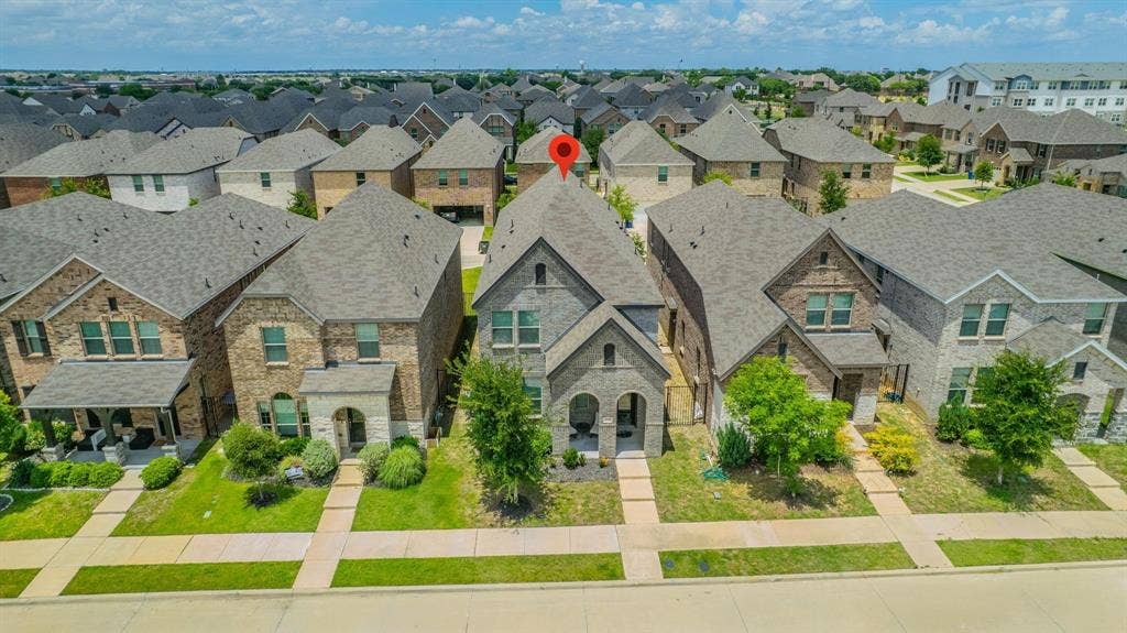 4129 Bullwhip Creek Lane, Sachse, TX 75048 Brick and stone exterior, gabled roofline, established front landscaping, concrete walkways, and mature trees