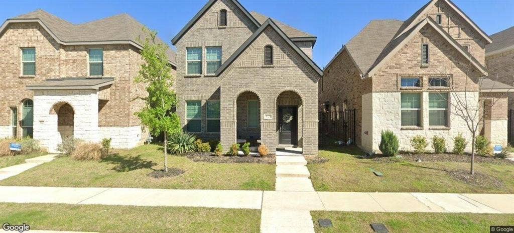4129 Bullwhip Creek Lane, Sachse, TX 75048 Brick and stone exterior with arched entryways, gabled rooflines, and a concrete walkway