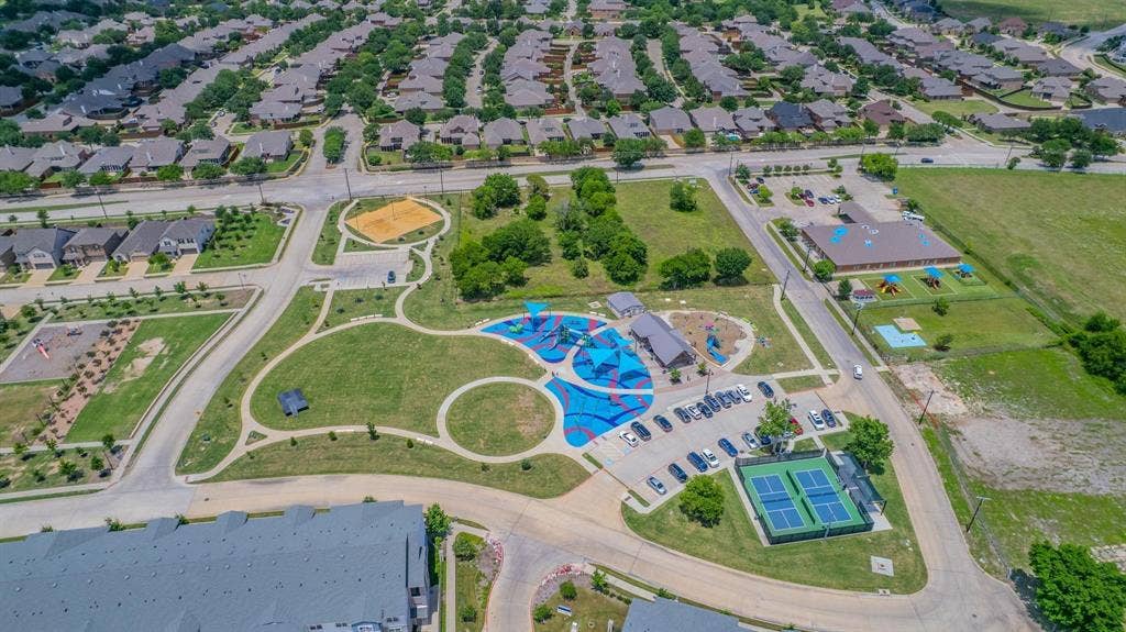 4129 Bullwhip Creek Lane, Sachse, TX 75048 Community green space featuring a playground, walking paths, tennis courts, and a sand volleyball court