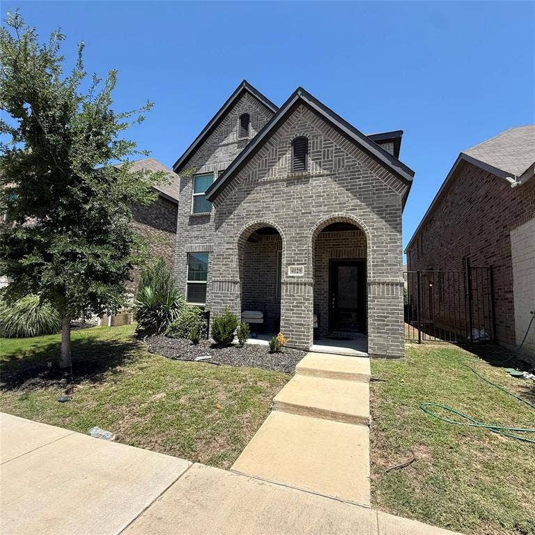 4129 Bullwhip Creek Lane, Sachse, TX 75048 Brick exterior with arched entryway