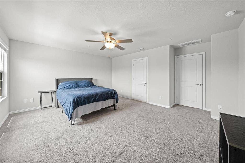 4129 Bullwhip Creek Lane, Sachse, TX 75048 Light-colored carpeted flooring, white interior doors, and a ceiling fan with integrated lighting