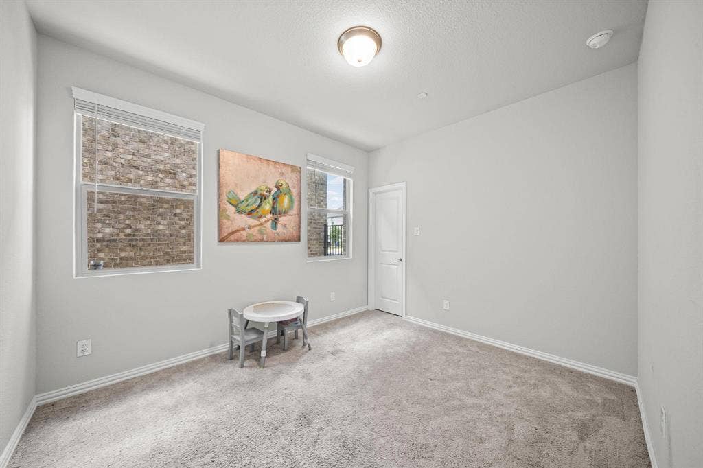 4129 Bullwhip Creek Lane, Sachse, TX 75048 Neutral wall color, wall-to-wall carpeting, two windows with blinds, ceiling-mounted light fixture, and white interior door