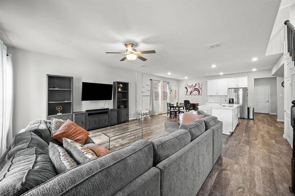 4129 Bullwhip Creek Lane, Sachse, TX 75048 Open-concept living space with wood-finish flooring, recessed lighting, and a ceiling fan