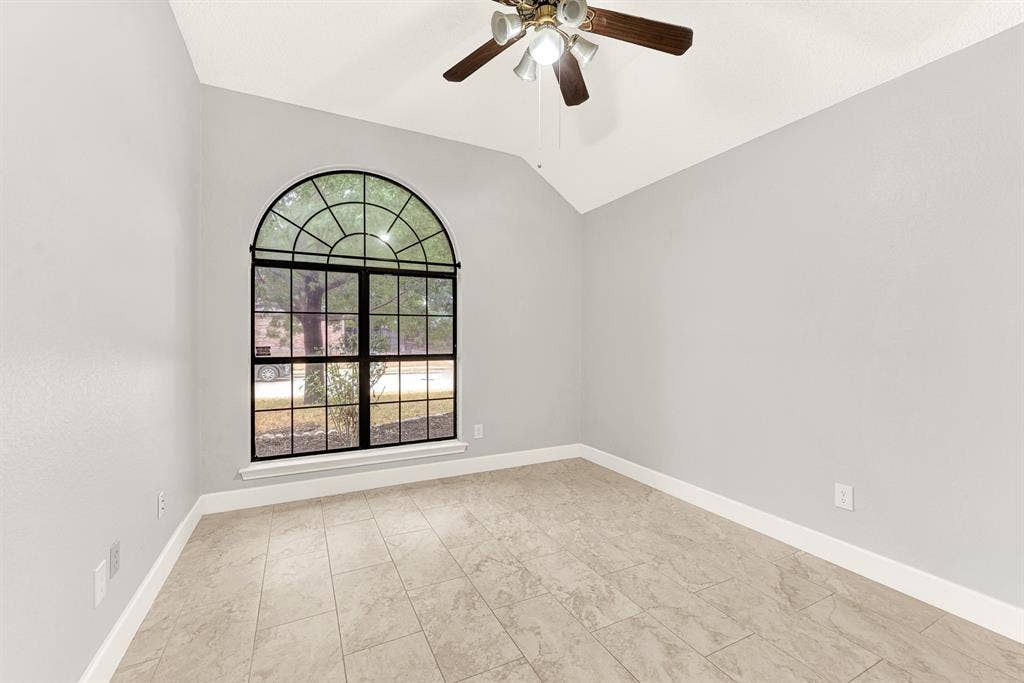 High vaulted lines draw the eyes upward while black window mullions frame serene outdoor greenery. Picture turning this quiet space into a creative home studio or peaceful nursery filled with soft morning light.