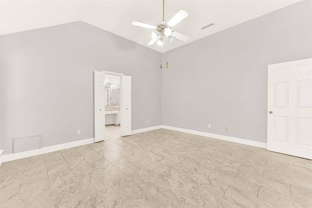 Double entry doors open seamlessly into the main bedroom, connecting high ceilings with effortless interior flow. You can easily picture slipping into comfortable loungewear after a long day in this tranquil space.
