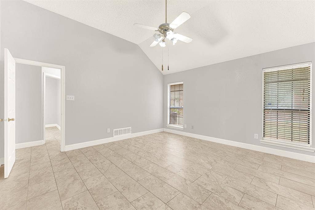 Clean neutral walls surround wide sightlines, enhancing the room's peaceful architectural symmetry. Imagine curling up with your favorite book in a cozy corner armchair during a quiet evening reset.