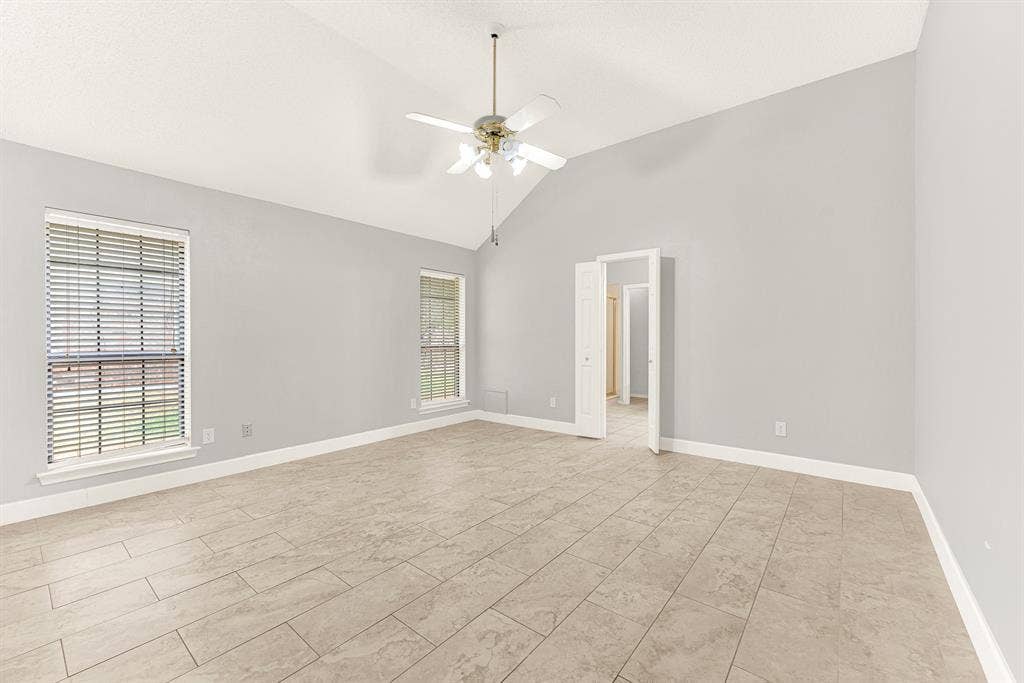 A dramatic vaulted ceiling rises above smooth tile floors, giving this spacious retreat a light and airy dimension. Picture waking up to soft morning rays filtering through double windows as you begin your day.