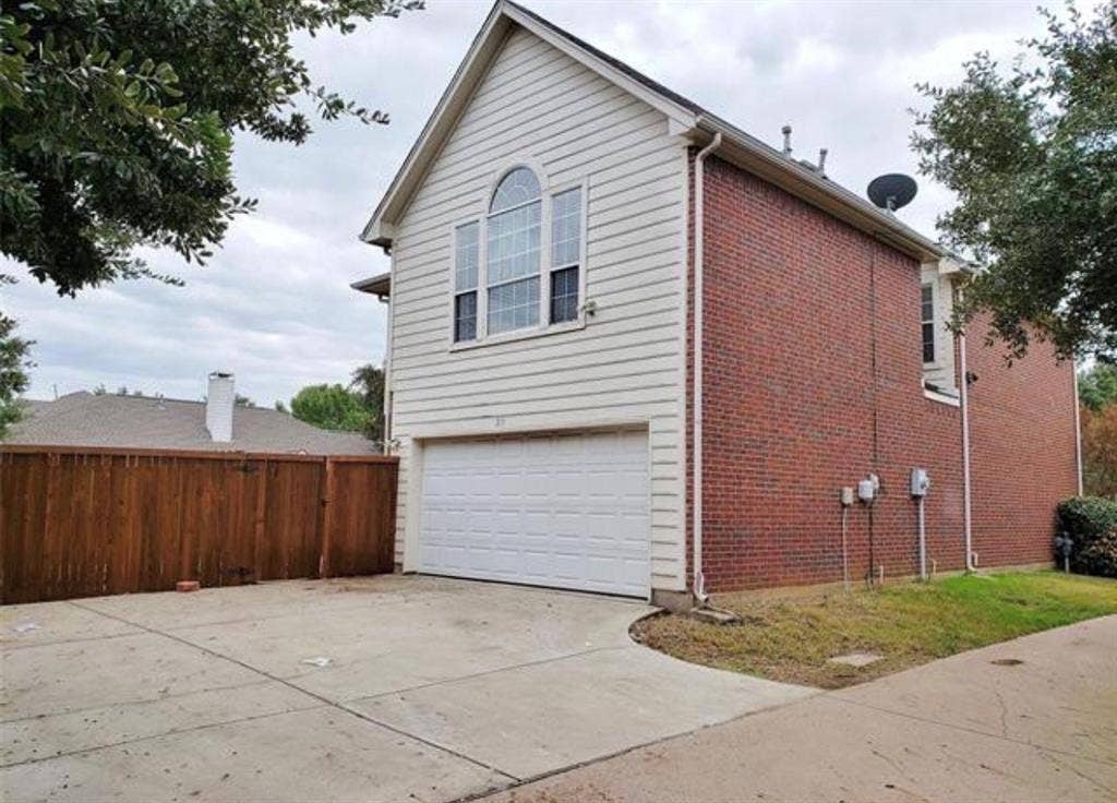 211 Moss Hill Road, Irving, TX 75063 Brick and siding exterior with a prominent arched window
