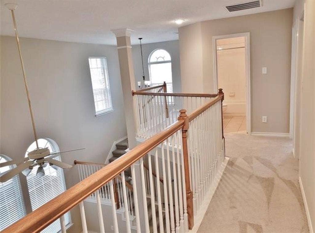211 Moss Hill Road, Irving, TX 75063 Two-story entryway with a ceiling fan, arched window, and traditional wood railings