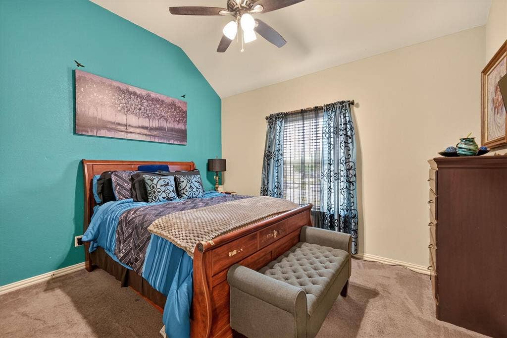 902 Nikki Drive, Cedar Hill, TX 75104 Vaulted ceiling with a ceiling fan, carpet flooring, window with blinds, and a built-in dresser