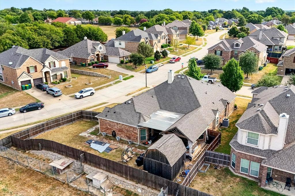 902 Nikki Drive, Cedar Hill, TX 75104 Brick veneer exterior with a covered patio and a wood fence