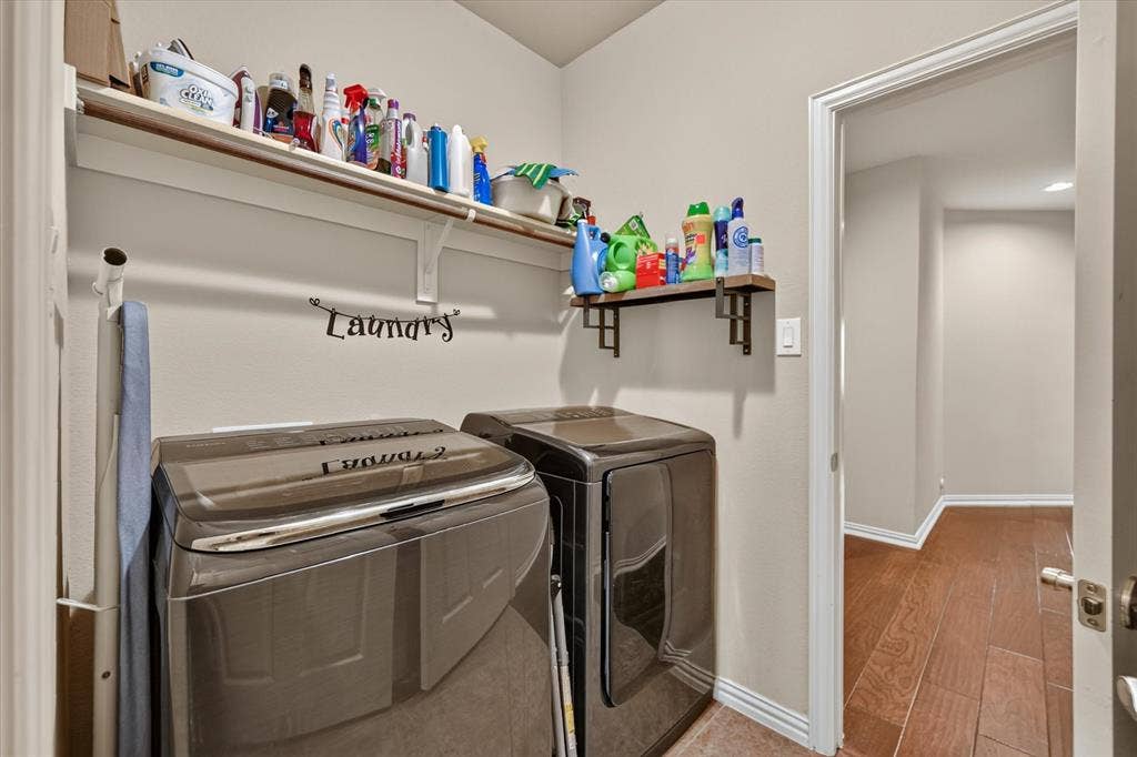 902 Nikki Drive, Cedar Hill, TX 75104 Spacious utility area featuring a built-in shelf, additional wall-mounted shelving, and wood-finish flooring
