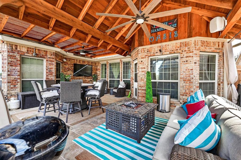 902 Nikki Drive, Cedar Hill, TX 75104 Covered outdoor patio featuring a wood-beamed ceiling, brick exterior, ceiling fans, and tiled flooring