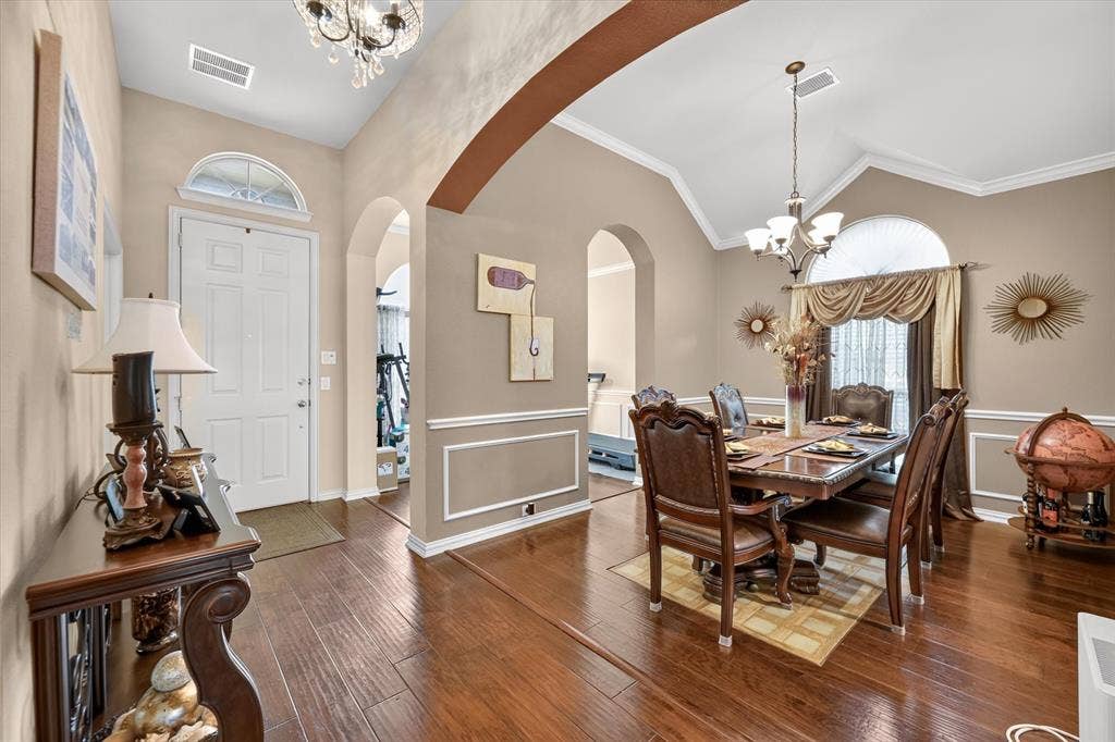 902 Nikki Drive, Cedar Hill, TX 75104 Hardwood flooring, vaulted ceiling, arched doorways, crown molding, and wainscoting