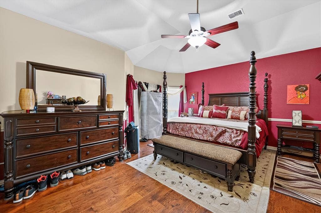 902 Nikki Drive, Cedar Hill, TX 75104 Tray ceiling with ceiling fan, wood-finish flooring, and painted accent wall