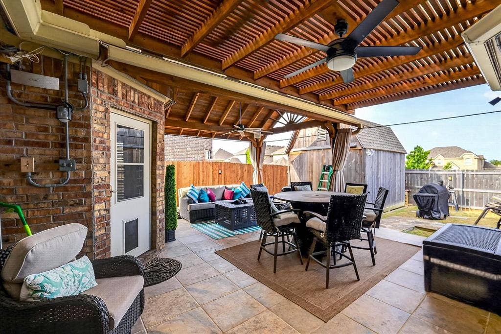 902 Nikki Drive, Cedar Hill, TX 75104 Covered patio featuring a wood-slat ceiling, dual ceiling fans, and tiled flooring