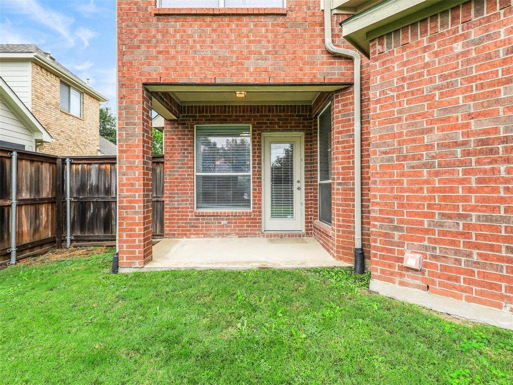 7419 Ravenhill Drive, Frisco, TX 75035 Brick exterior with covered patio and concrete flooring