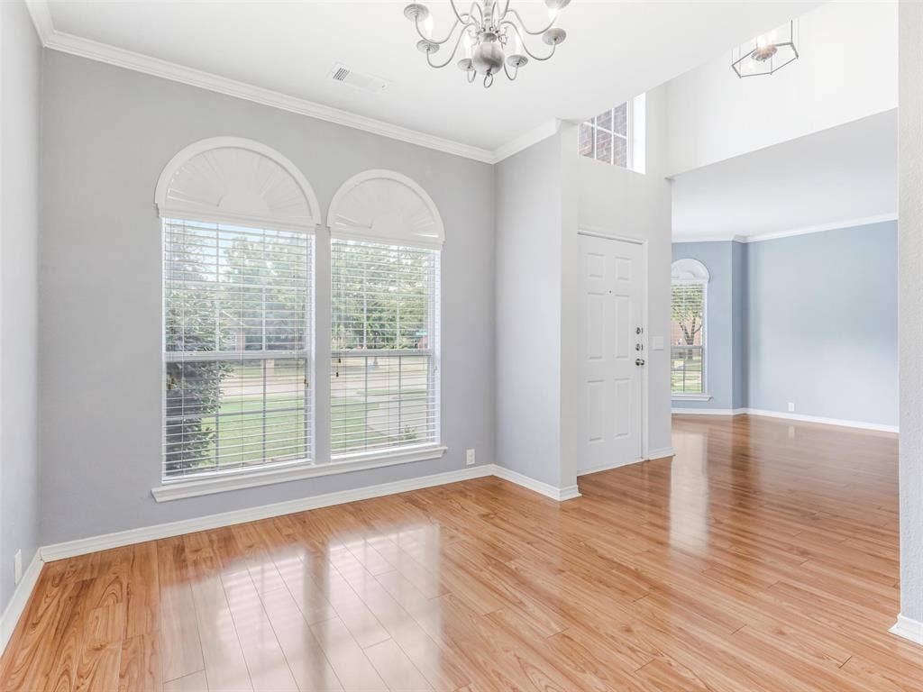 7419 Ravenhill Drive, Frisco, TX 75035 Wood-finish flooring throughout, complemented by crown molding and arched windows