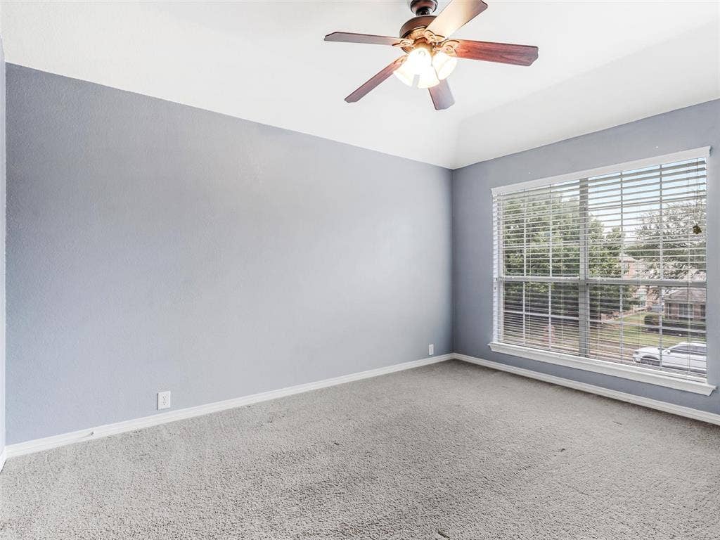 7419 Ravenhill Drive, Frisco, TX 75035 Vaulted ceiling, ceiling fan with light fixture, large window with blinds, and carpeted flooring