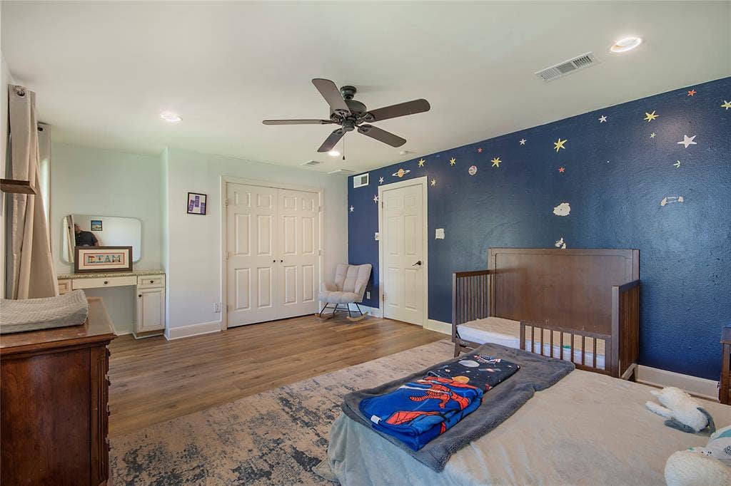 4074 Cedar Bayou Drive, Dallas, TX 75244 Recessed ceiling lighting, wood-finish flooring, ceiling fan, white paneled doors, and built-in vanity with countertop
