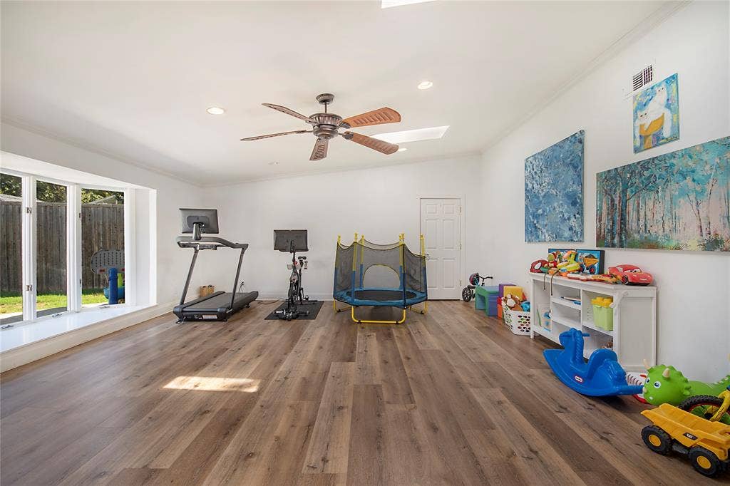 4074 Cedar Bayou Drive, Dallas, TX 75244 Spacious room with wood-finish flooring, a large bay window, and a ceiling fan