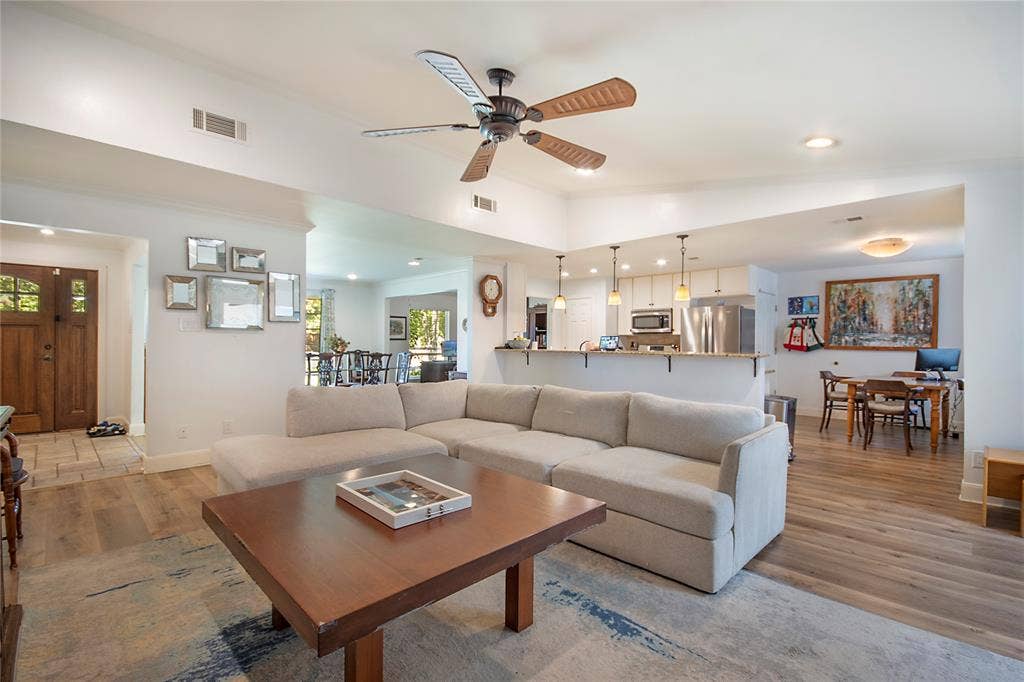 4074 Cedar Bayou Drive, Dallas, TX 75244 Open-concept living area featuring a sectional-ready layout with hardwood flooring throughout