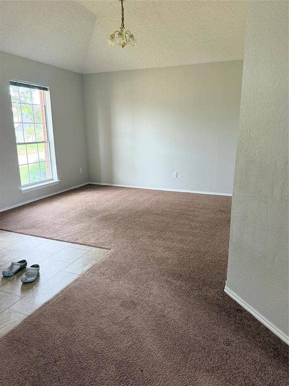 437 Kimmel Drive, Cedar Hill, TX 75104 Vaulted ceiling with an attached chandelier, neutral wall paint, and a large window