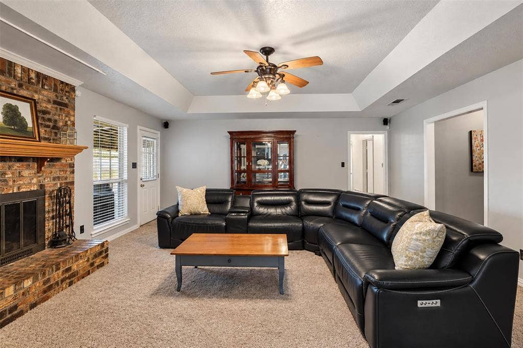 1920 Big Sky Drive, Lewisville, TX 75077 A welcoming living room with a fireplace and plenty of room to unwind.