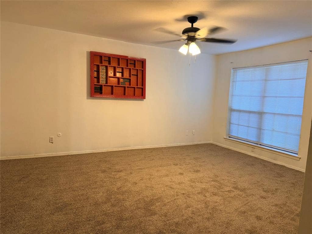 12888 Montfort Drive, #167, Dallas, TX 75230 Wall-to-wall carpeting with a ceiling fan light fixture and window with blinds