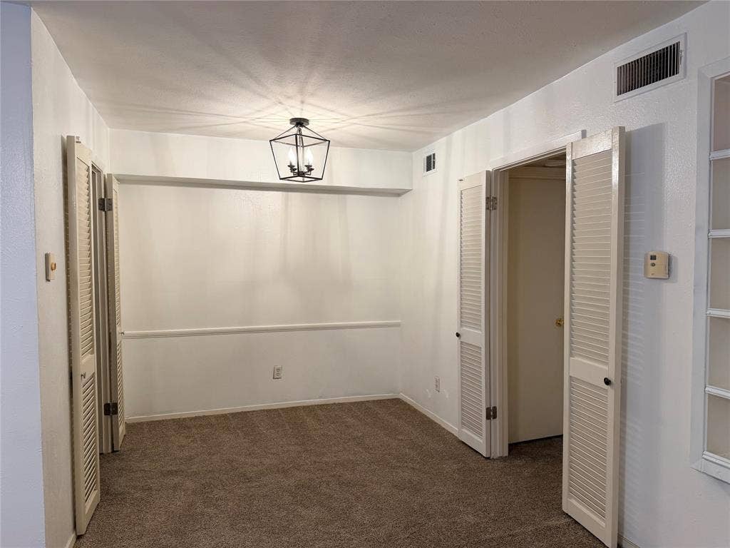 12888 Montfort Drive, #167, Dallas, TX 75230 Recessed lighting, ceiling-mounted light fixture, louvered bi-fold doors, white interior paint, and brown carpet flooring