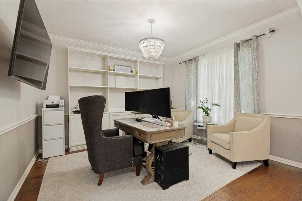 Dedicated home office with built-in shelving and cabinetry, designer lighting, and a functional workspace perfect for working from home.