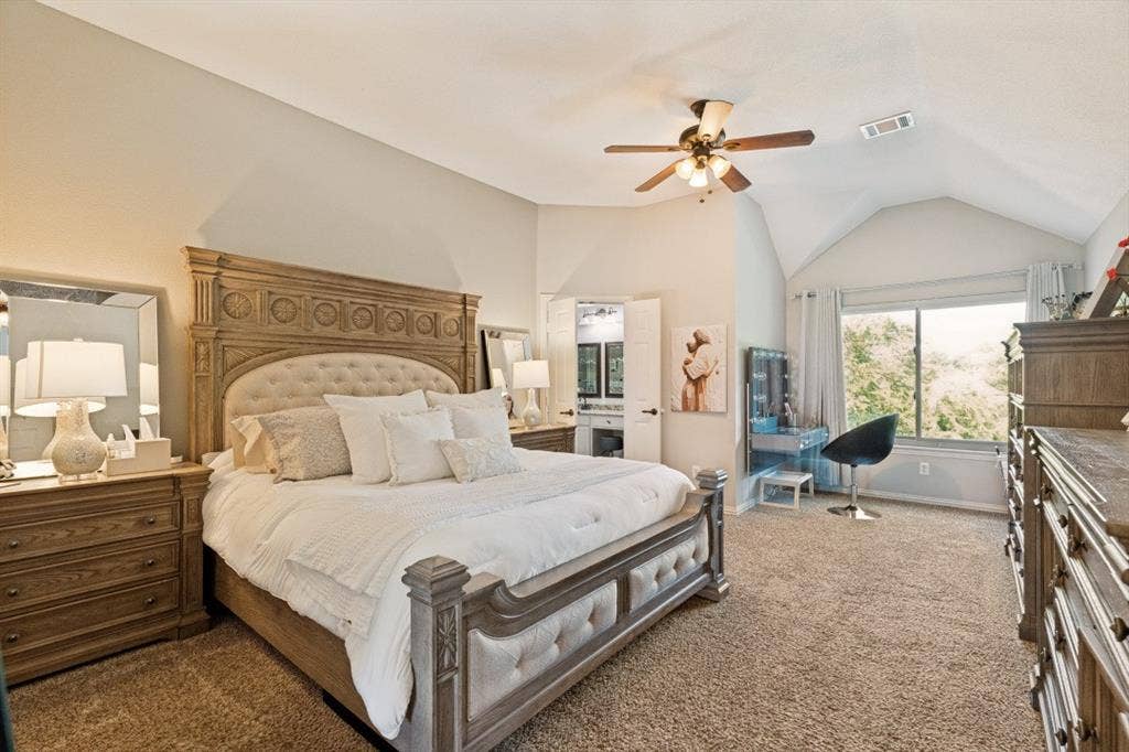 Spacious primary suite featuring a cozy sitting area, large windows, and plenty of room to relax and recharge.