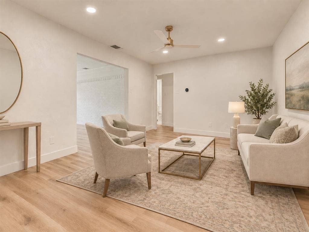 Virtually staged living room showcases flexible seating and entertaining space.