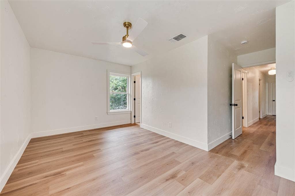 Additional primary bedroom view shows ample space for furnishings.