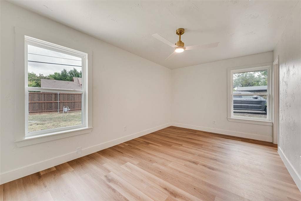 Bright primary suite with large windows and a generous, flexible layout.