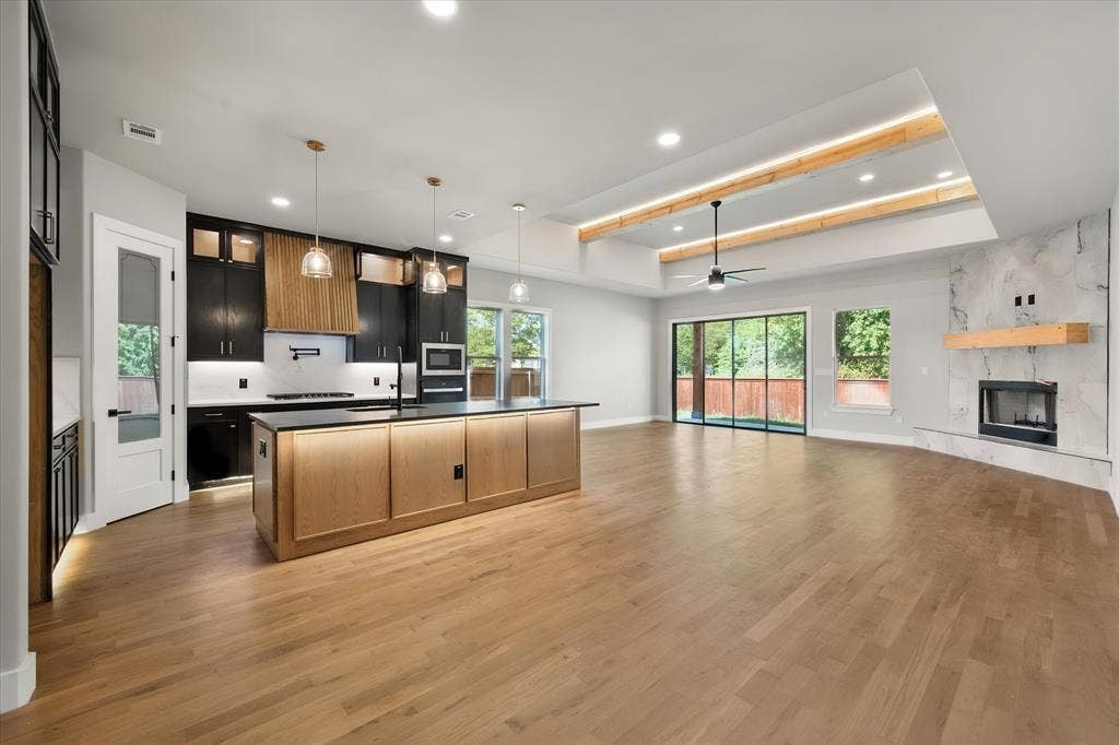Open-concept living space with wood-finish flooring