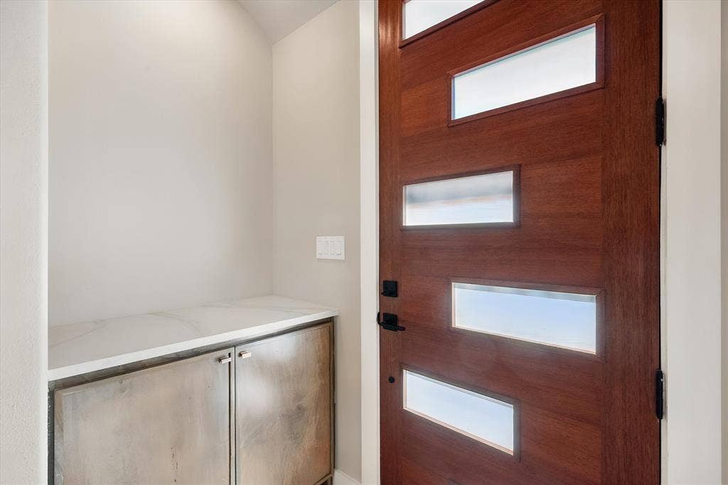 Contemporary wood-finish entry door with frosted glass inserts