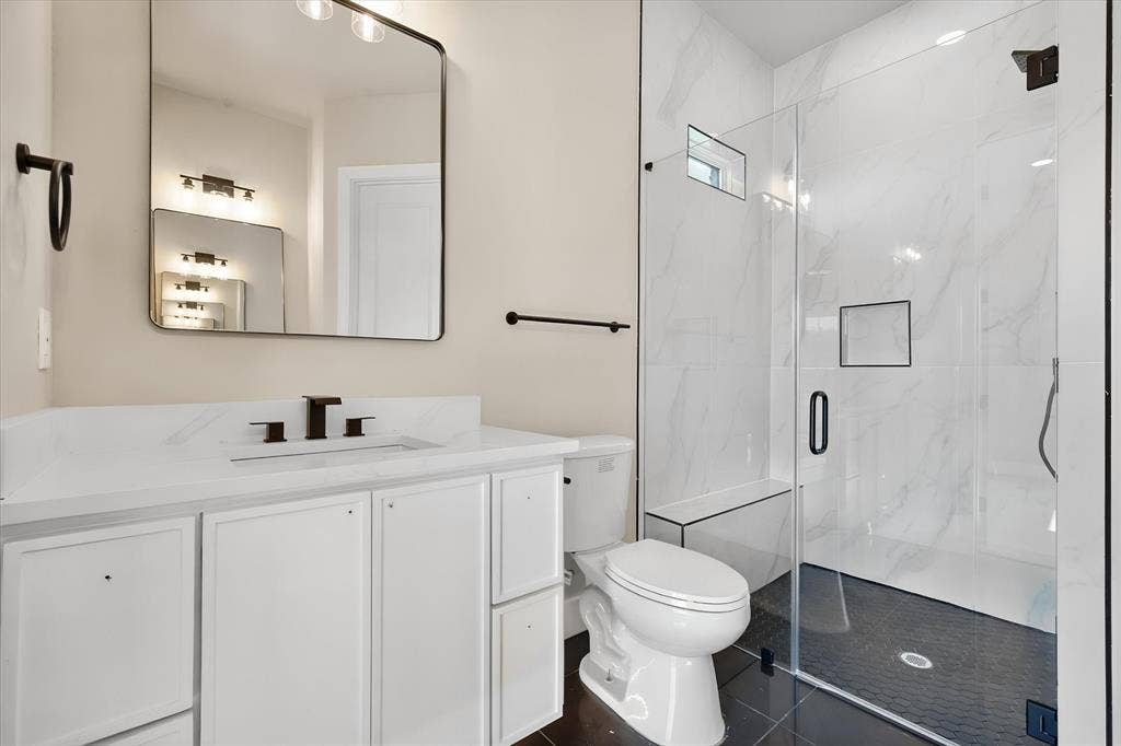 White vanity with an integrated sink and matte black faucet