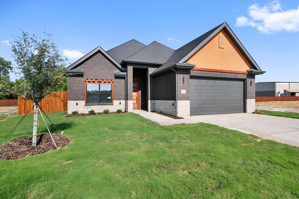 Brick and stone exterior with a dark asphalt shingle roof