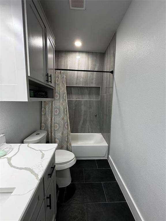 3207 NW 30th Street, Fort Worth, TX 76106 White vanity with a stone-finish countertop, gray cabinetry featuring matte black hardware, black tile flooring, and a shower/tub combination with a tiled surround