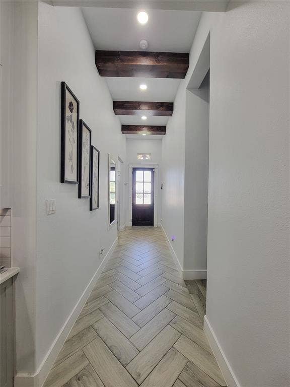 3207 NW 30th Street, Fort Worth, TX 76106 Hallway featuring recessed lighting, exposed wood beams, herringbone-patterned wood-finish flooring, and a paneled front door with glass inserts