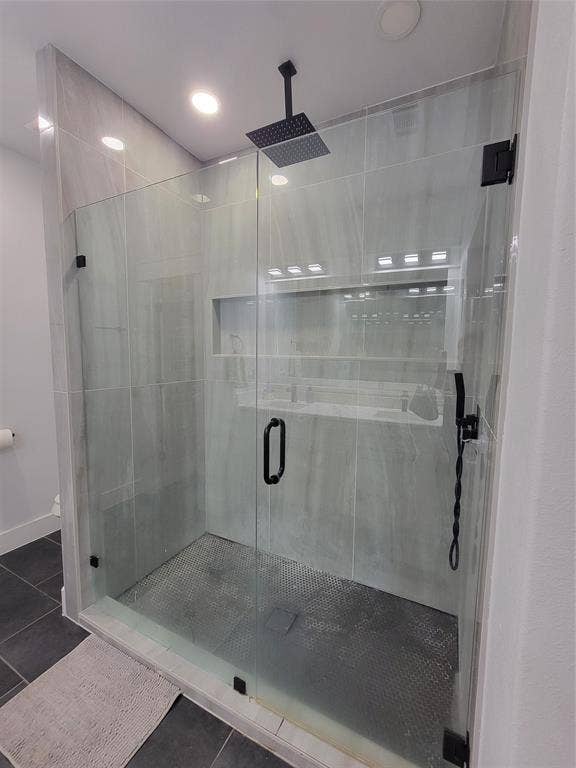 3207 NW 30th Street, Fort Worth, TX 76106 Enclosed shower with frameless glass, matte black hardware, rain shower head, and tiled walls