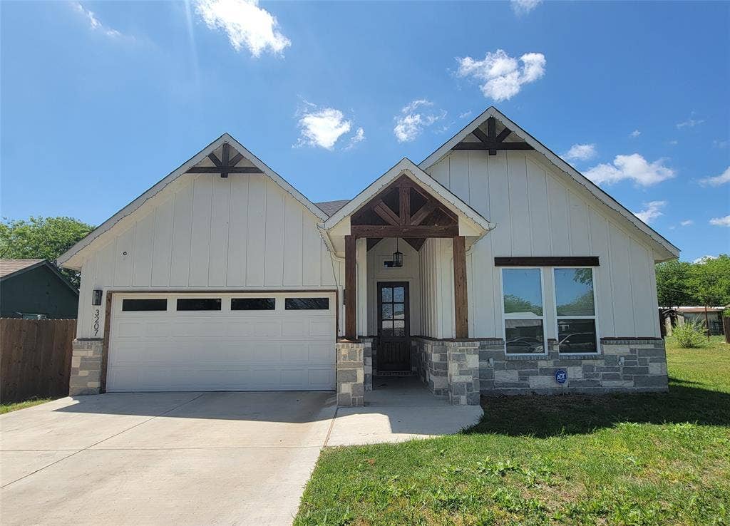 3207 NW 30th Street, Fort Worth, TX 76106 Modern farmhouse exterior with white board and batten siding, stone accents, and a covered entry