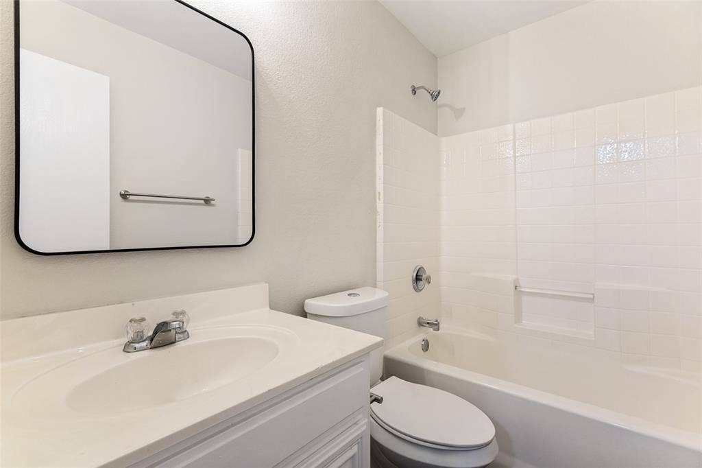 4545 Grainland Court, Fort Worth, TX 76179 White vanity with integrated sink, chrome faucet, and rectangular mirror