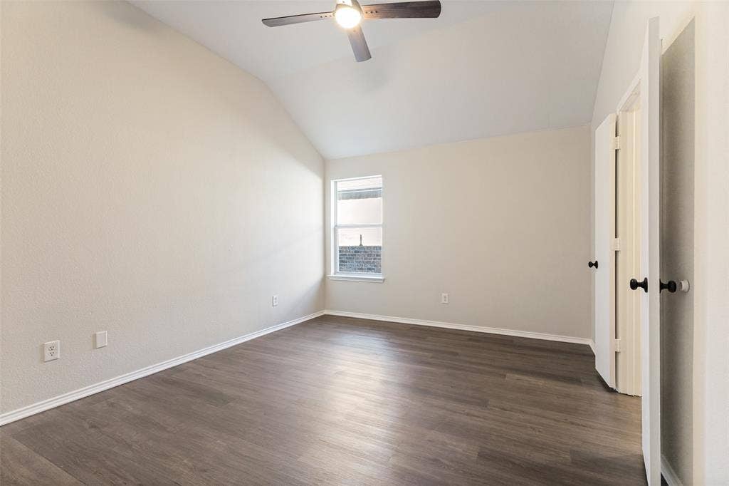 4545 Grainland Court, Fort Worth, TX 76179 Vaulted ceiling with a ceiling fan, wood-finish flooring, and a multi-pane window