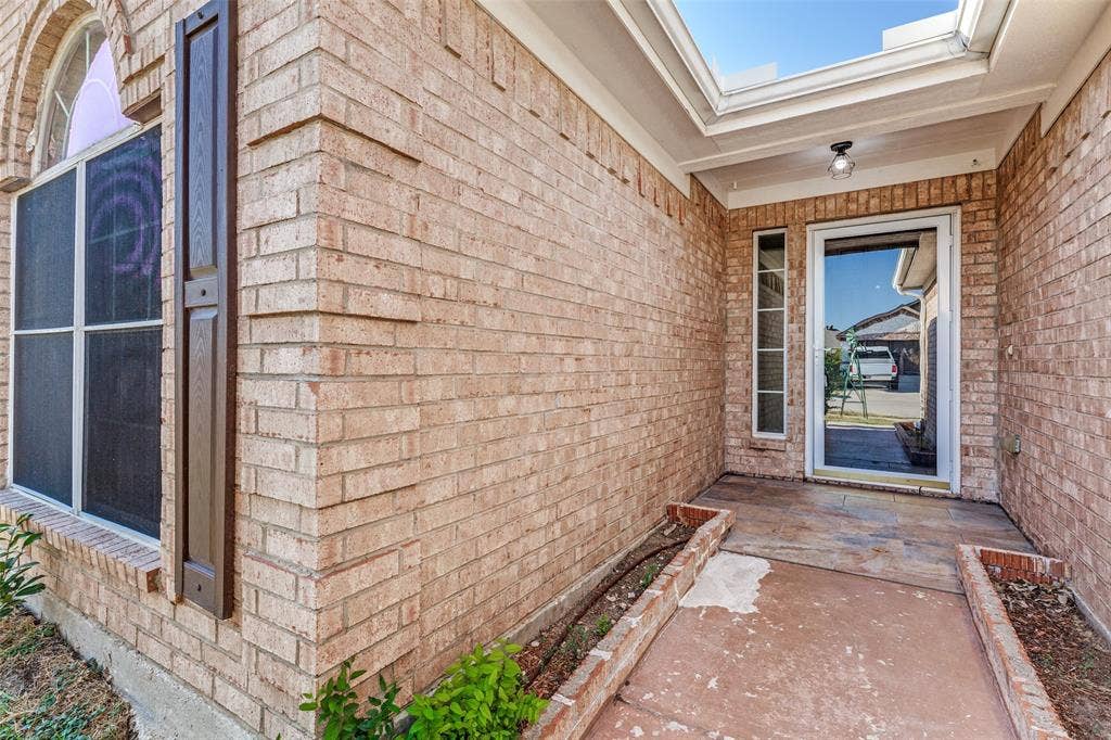 4545 Grainland Court, Fort Worth, TX 76179 Brick exterior facade with a covered entry