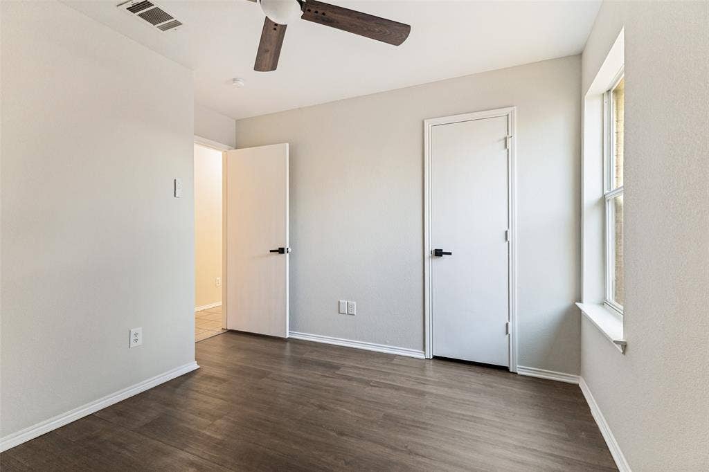 4545 Grainland Court, Fort Worth, TX 76179 Wood-finish flooring, white walls, ceiling fan, and white trim