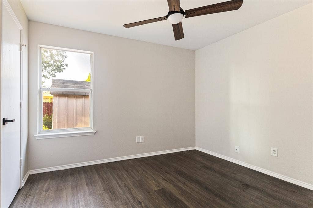 4545 Grainland Court, Fort Worth, TX 76179 Wood-finish flooring, white trim, single window, and a ceiling fan with integrated lighting