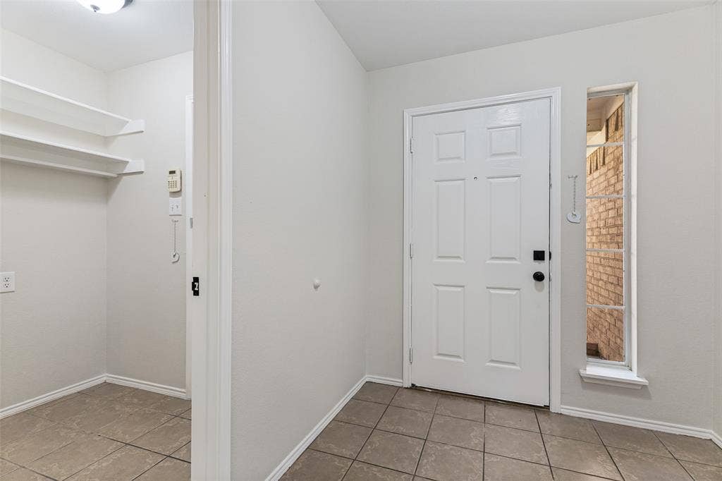 4545 Grainland Court, Fort Worth, TX 76179 White paneled entry door, sidelight window, and tile flooring